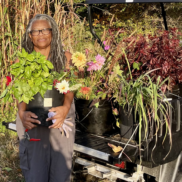 Beverly Boone Meek holding buckets of blooms