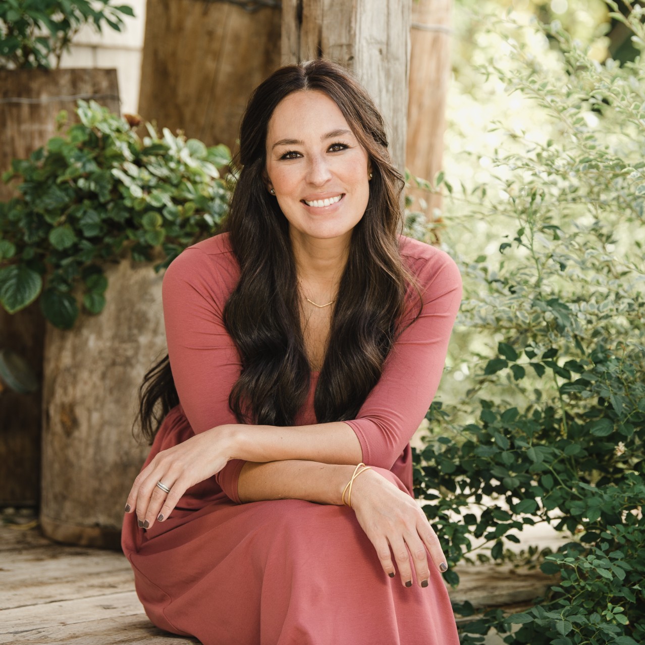 Joanna Gaines Floret sitting on a porch smiling